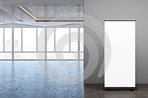 Empty modern spacious interior design with empty white mock up roll-up banner, panoramic windows and city view, reflections on