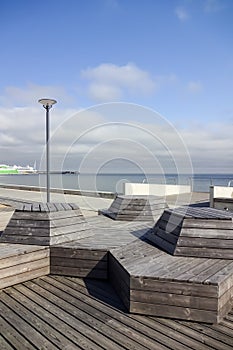 Empty modern wooden benches or construction for sitting on new Reidi promenade (Reidi tee in Estonian) by the seaside of