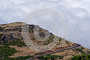 Empty mountain road against dense clouds on Pico do Arieiro on Madeira island photo