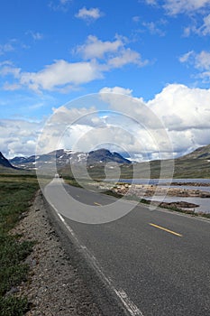 Empty mountain road landscape Norway mountains summer blue sky clouds travel highway rural country nature asphalt green beautiful