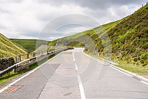 Empty mountain road o cloudy summer day