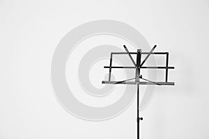 Empty music note stand on white. Space for text