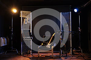 Empty music recording studio with guitar on chair