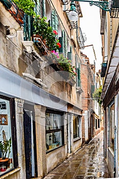 Empty narrow alleyway brick/cobblestone street in Venice, Italy