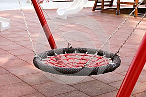 Empty nest swing on outdoor playground in residential area