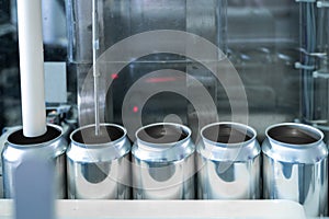 Empty new aluminum cans for drink process in factory line on conveyor belt machine at beverage manufacturing. food and