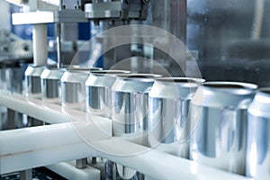 Empty new aluminum cans for drink process in factory line on conveyor belt machine at beverage manufacturing. food and