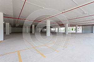 Empty new parking garage underground interior in apartment or business building office and supermarket store