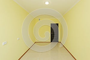 Empty new room with yellow walls in the apartment