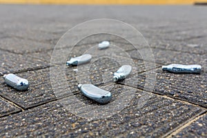 Empty nitrous oxide bulbs lying scattered on the street