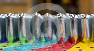 Empty nitrous oxide cannisters reflecting psychedelic colours