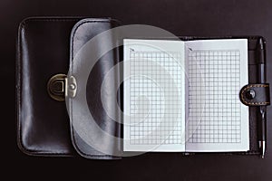 empty notebook with a black bag