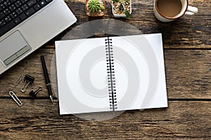 Empty notebook and computer on wooden table