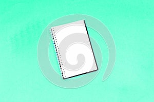 empty notebook isolated on color paper background. photo