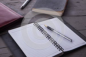 Empty notebook with office equipments on desk.