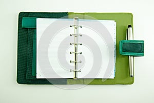 Empty notebook with a pen