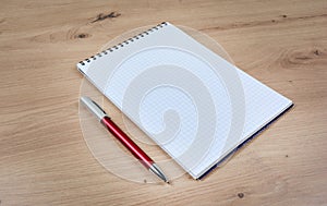 Empty notebook with pen on a wood table