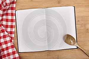 Empty notebook for recipes with spoon and