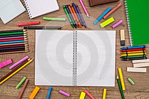 Empty notepad with color chalks and pencils