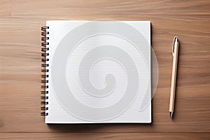 An empty notepad lying next to a pen on a wooden background