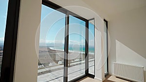 Empty oceanfront penthouse tour showcasing spacious rooms, panoramic views, high-end real estate, modern design