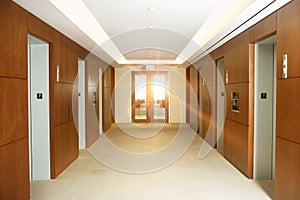 Empty office corridor by elevators on 7th floor of building