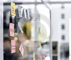 Empty office, sticky notes and glass for ideas or planning, schedule and agenda solution or information. Workplace