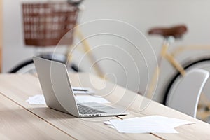 Empty office worker workplace, modern wooden table with laptop