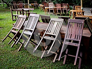 Empty old abandoned wooden dining table set on the green yard garden.