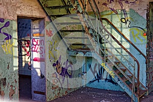 Empty old building full of vandalisms in the walls