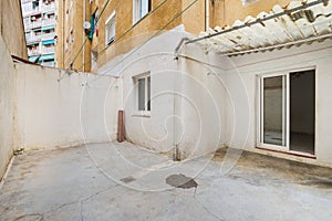 Empty and old patio of typical apartment in Barcelona. Worn out courtyard on lowest floor.