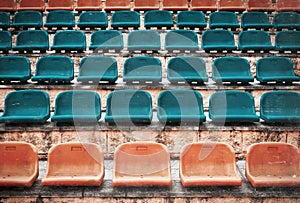 Empty old plastic seats at stadium, open door sports arena.