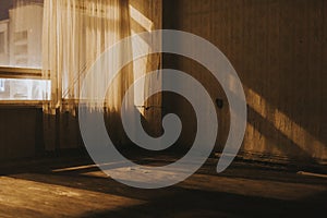 Empty old room with sheer curtains