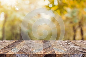 Empty old rustic wood plank table top with blur forest tree with