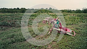 Empty old stroller in a field against the sky, an inverted baby carriage without a child