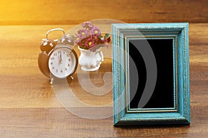 Empty of old style antique wooden photo frame and alarm clock wi