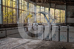 Empty old swimming pool in the abandoned school building located in the Chernobyl ghost town