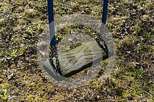 Empty old swing on playground