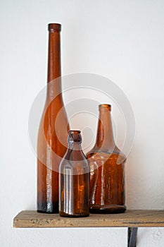 Empty old vintage wine glass bottles on the wooden shelf