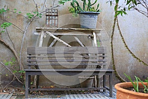 Empty of Old wooden chair in the garden against old cement wall background