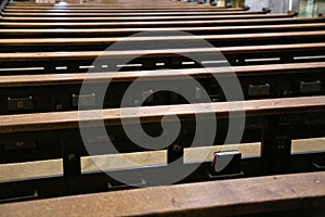 Empty old and wooden church pews without people