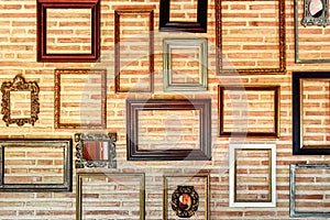 Empty old wooden frames to originally decorate an interior brick wall