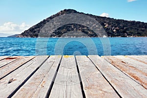 Wooden planks, sea and island photo