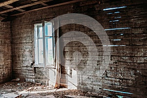 Empty old wooden room in an abandoned building. Window light is shining in. Abandoned Attic in Old House.View from the inside