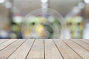 Empty old wooden table with blur and bokeh of light in cafe and restaurant background. Can be used for your photo montage. Space