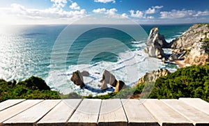 Empty old wooden table and View of Atlantic Coast at Portugal, Cabo da roca photo