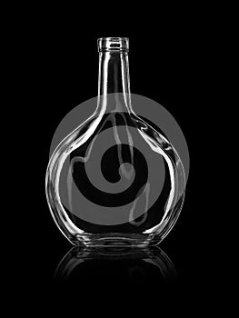 Empty open bottle for alcoholic beverages, isolated against a black background