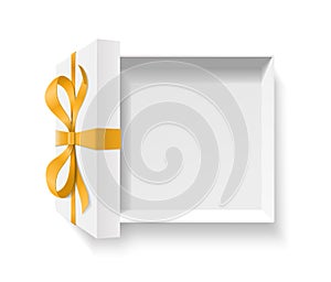 Empty open gift box with gold color bow knot and ribbon isolated on white background.