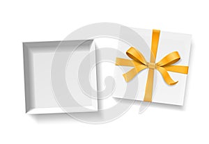 Empty open gift box with gold color bow knot and ribbon isolated on white background.