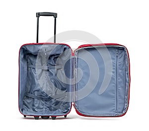 Empty and open red suitcase on wheels, isolated on white background. File contains a path to isolation
